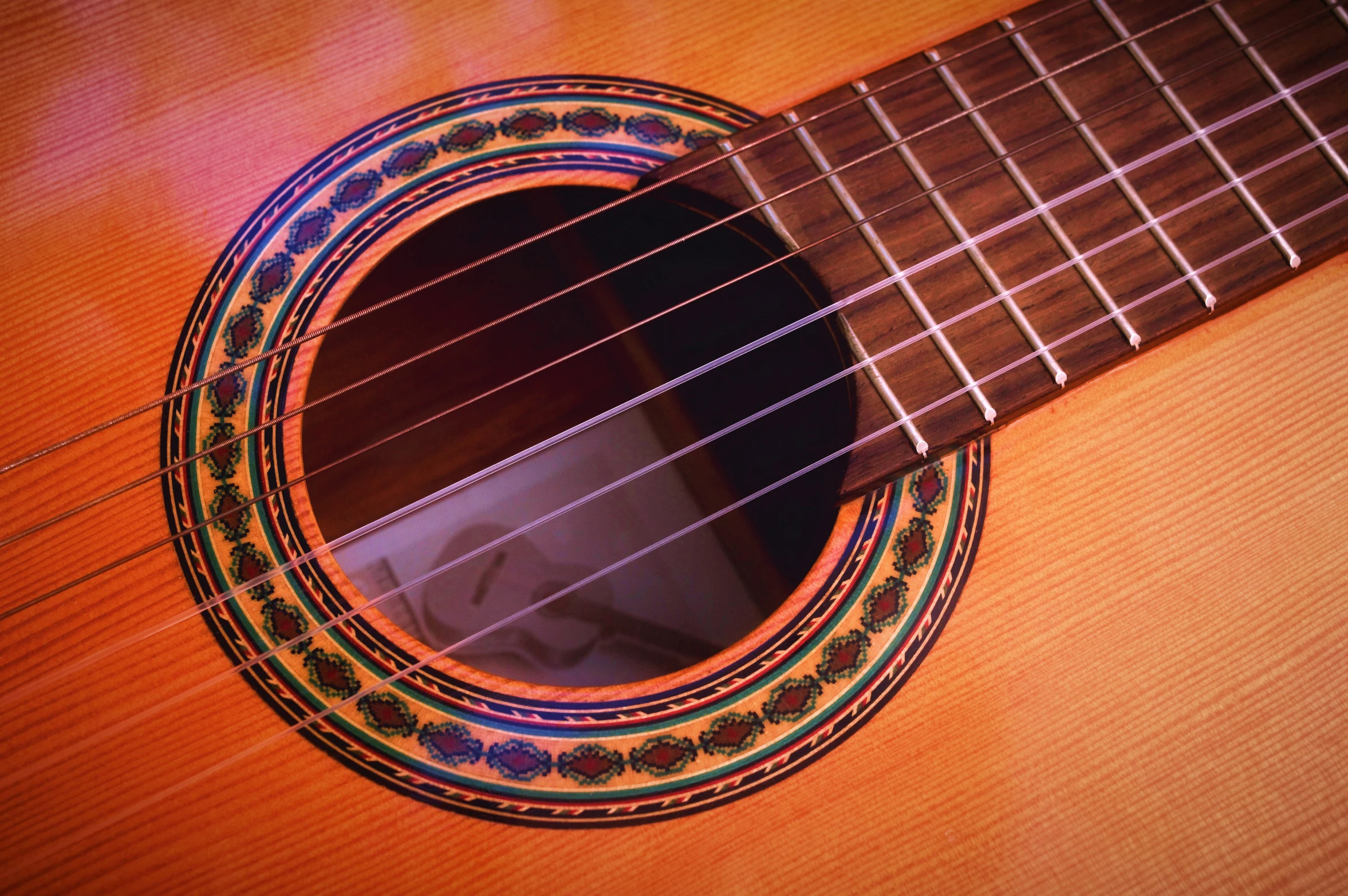 an acoustic guitar that is showing the frets