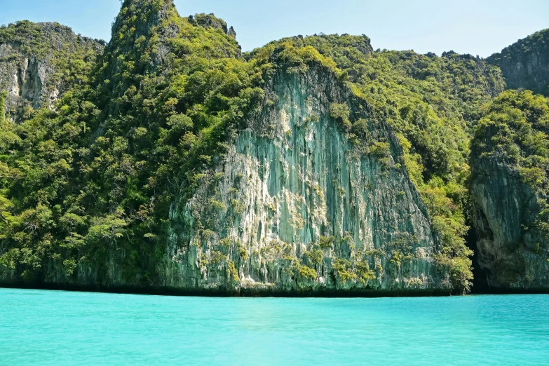 a large rock in the middle of water