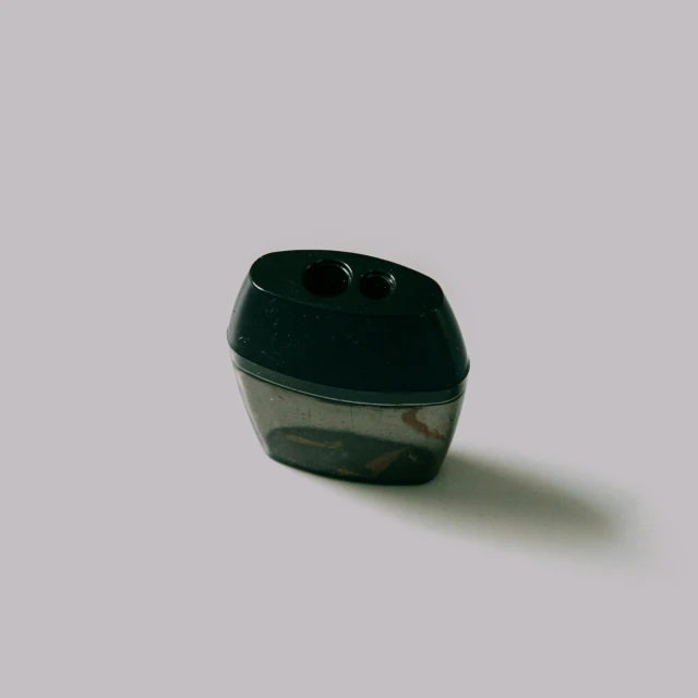 the bottom of a black cup on a white surface