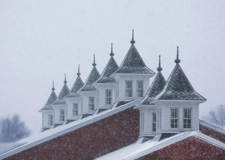 snow is falling on a building and roof