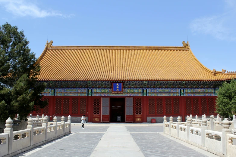 an oriental style building with red trim is on display