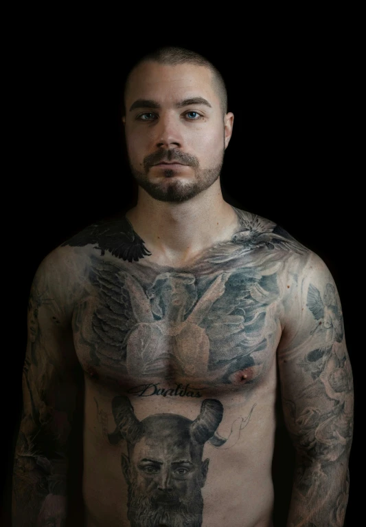 a man with lots of tattoos on his torso