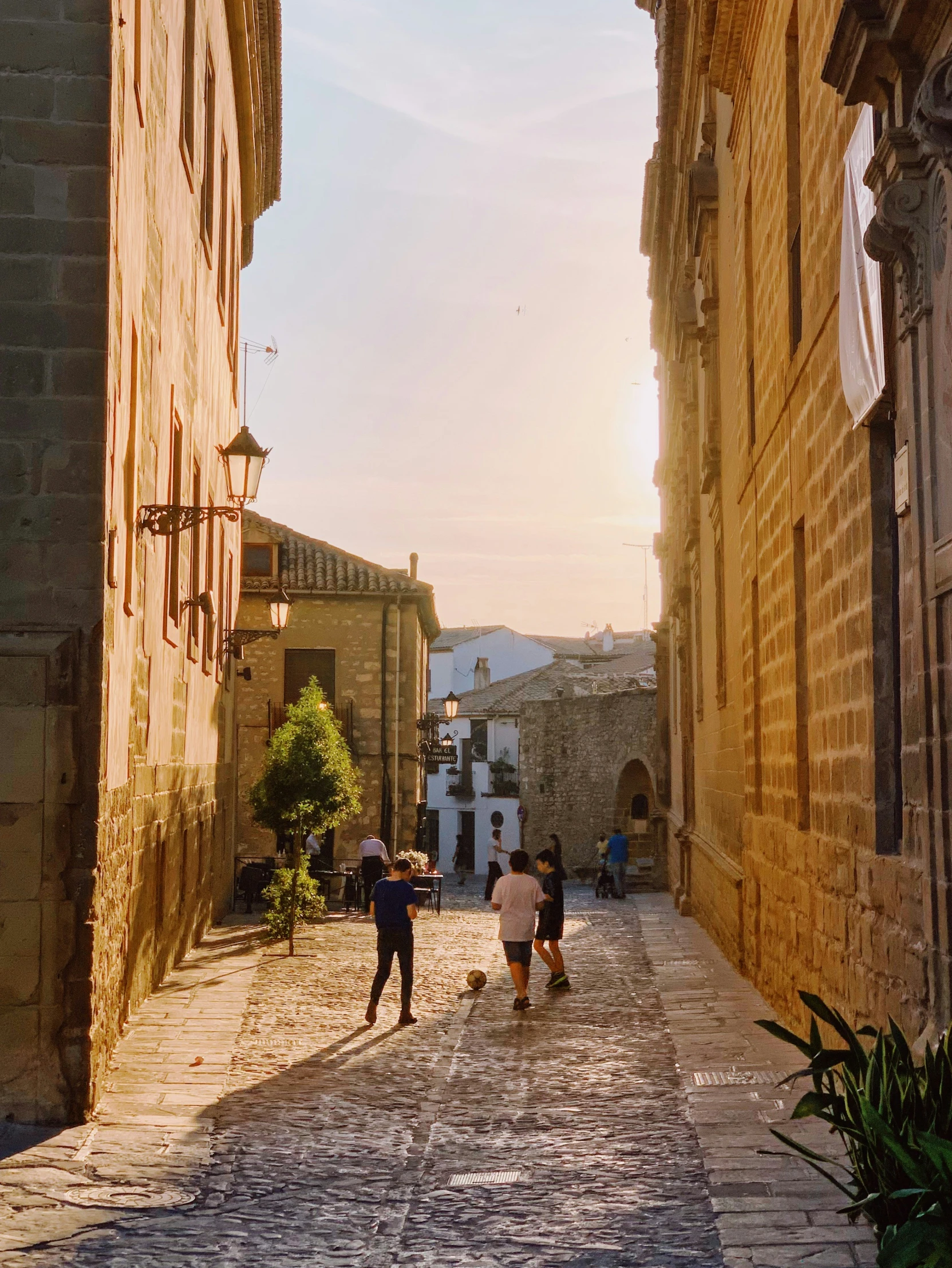 children are in the street playing with a frisbee