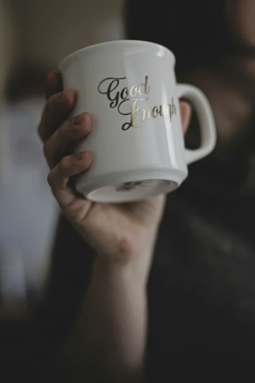 a woman holding up her coffee mug