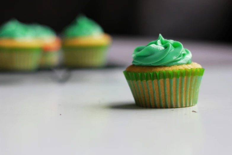 a close up of two cupcakes with frosting