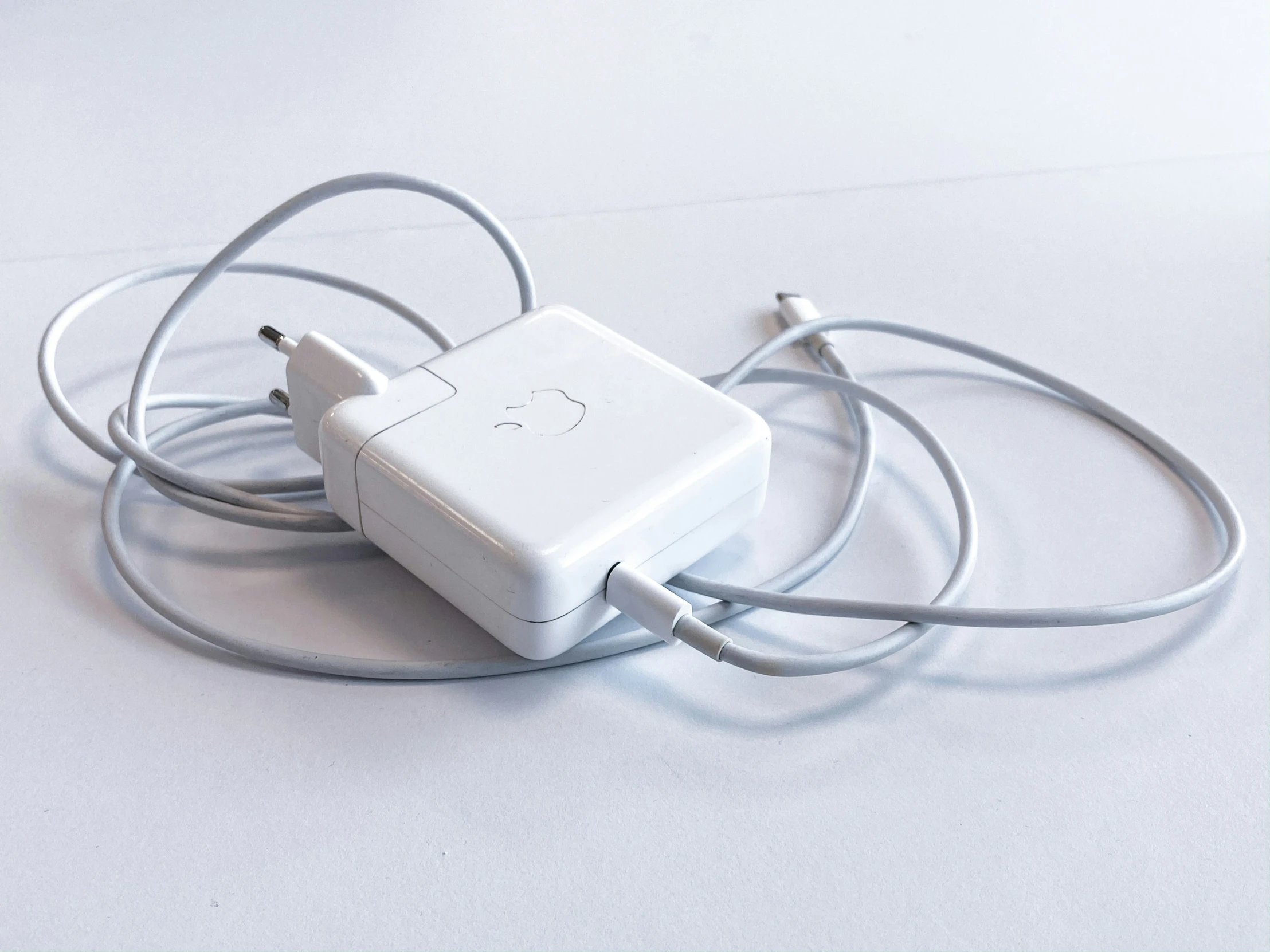 a small, square white object is plugged into a charger