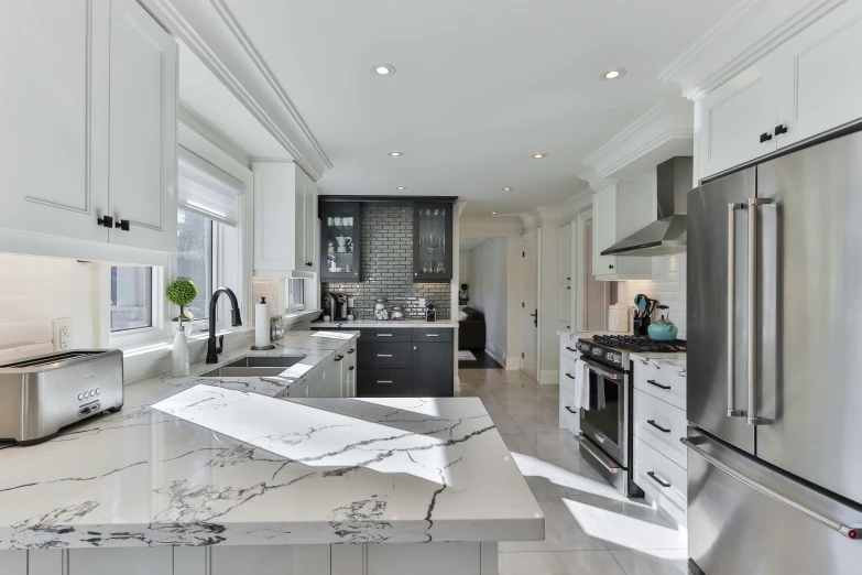 a large open plan kitchen with a marble countertop