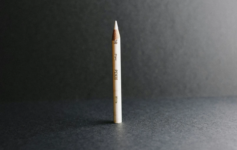 a pencil is sitting on the table with a white eraser