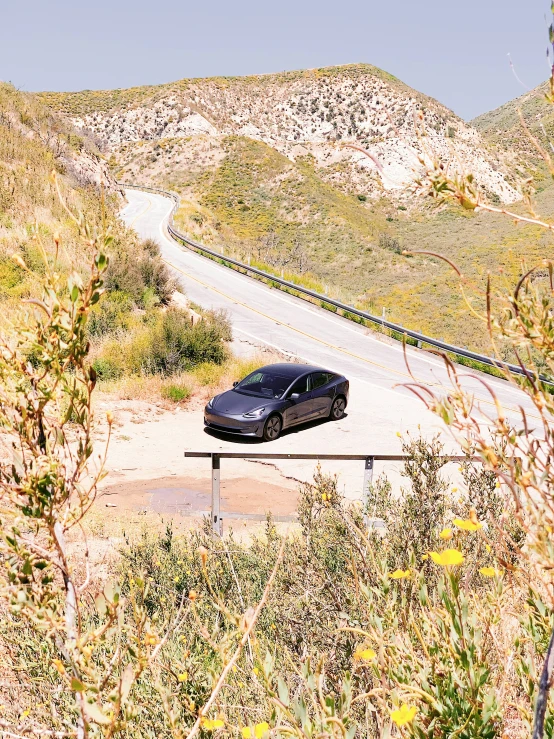 a car on a metal fence in the middle of nowhere