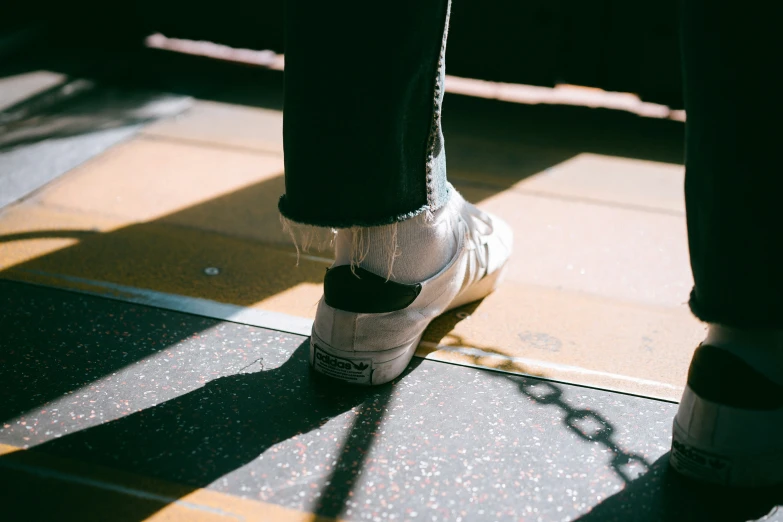 someone's shoes on the ground outside of their feet