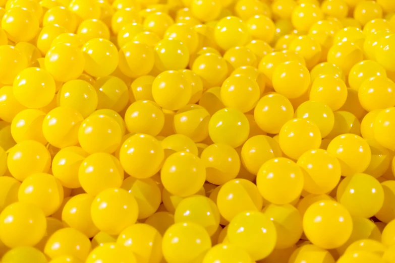 a large pile of yellow jelly balls