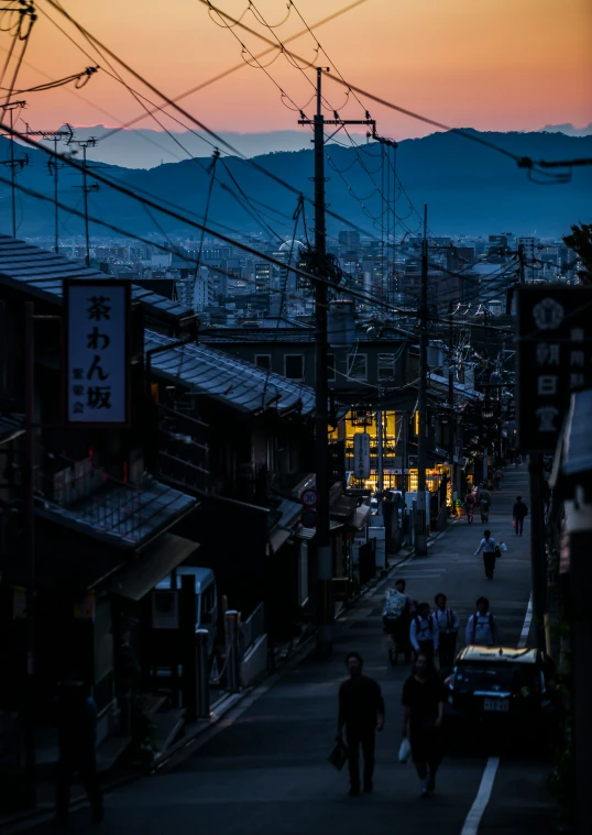 people are walking down the street at night