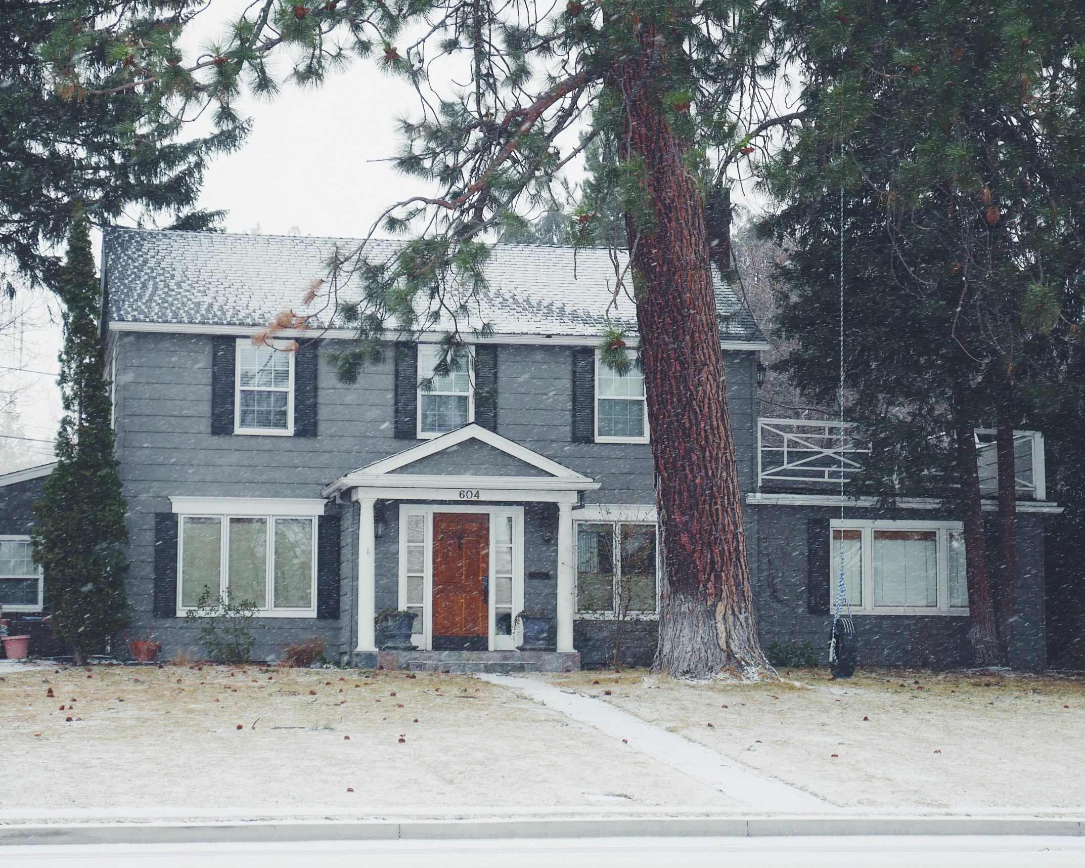 a house is on the corner with snow on it