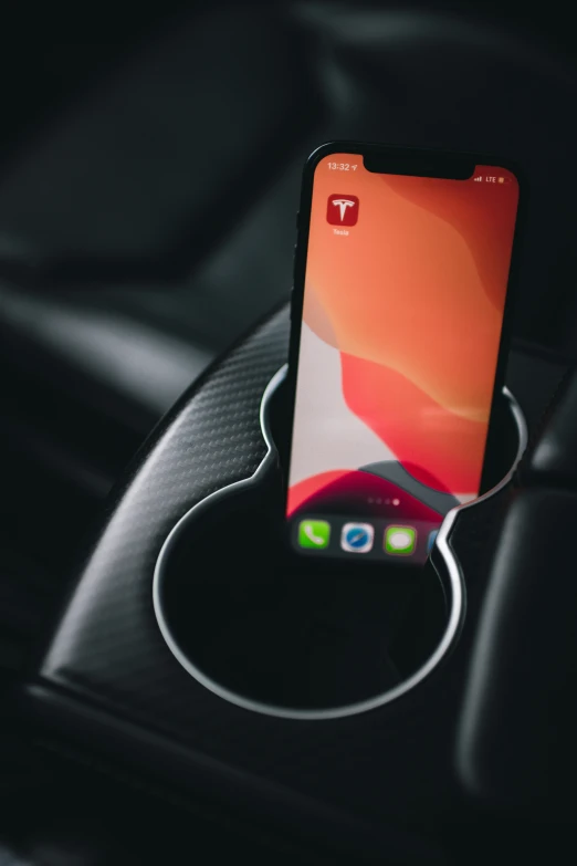 a cell phone in a charging unit on the car