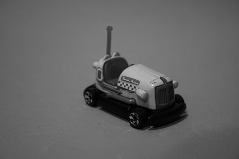 a toy tractor has wheels and a radio on it