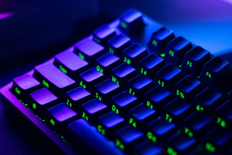 there are green letters on a purple and blue keyboard