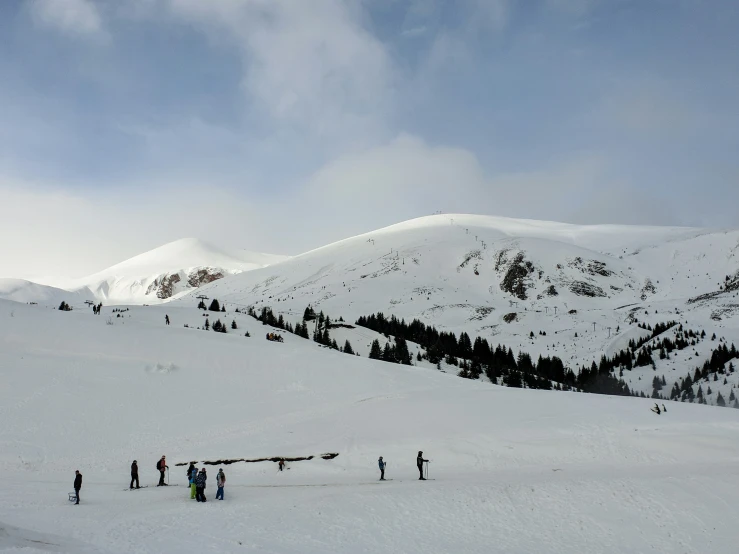 people skiing on the slopes of a mountain in winter