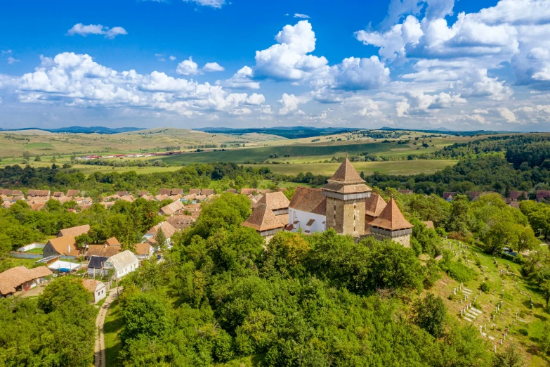 an old building with an impressive landscape can be seen from the height of a hill