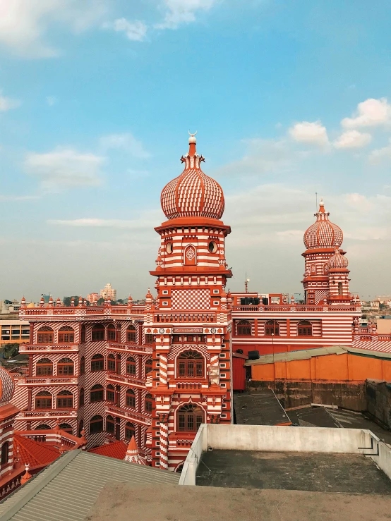 an old building with two towers and red tile