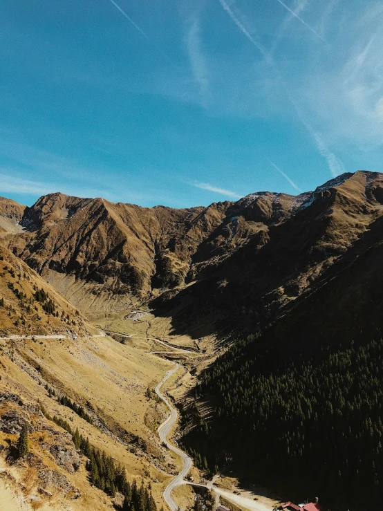 a scenic landscape shows a highway through the mountains