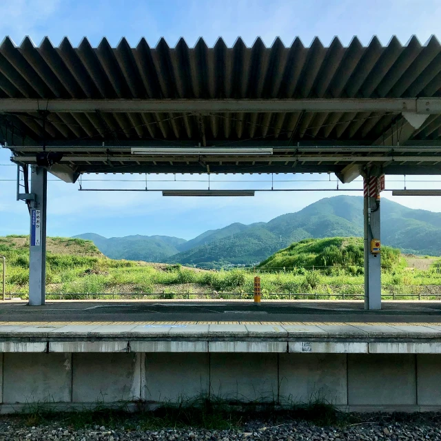 view over the landscape with a bench and mountain range