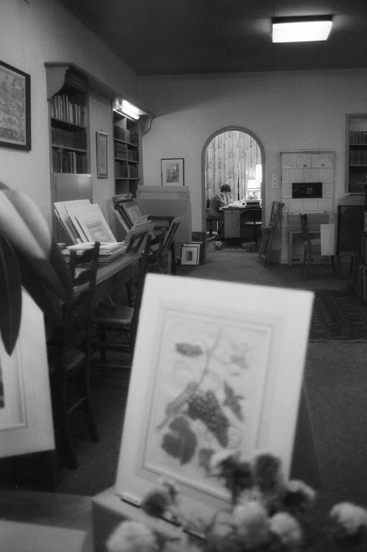 the black and white po shows some books in a room