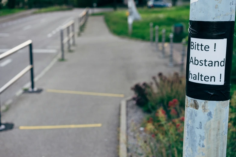 there is a street and a sign on the post