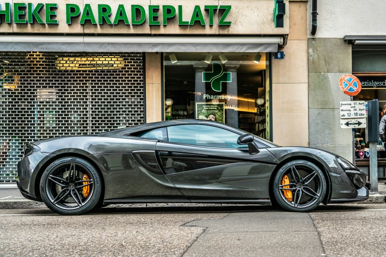 a gray sports car parked on the side of a road