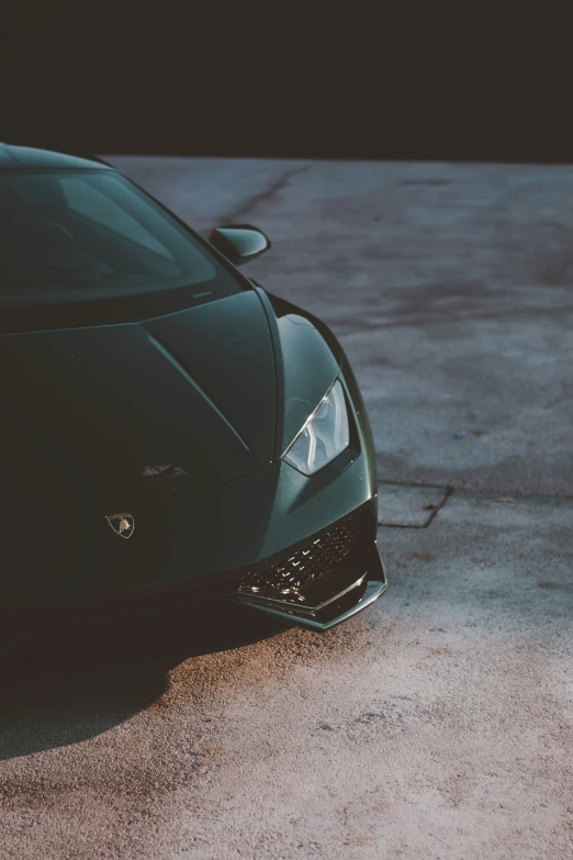 the back end of a sports car sitting on a cement floor