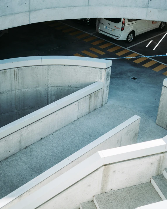 an open garage with stairs leading to a car park