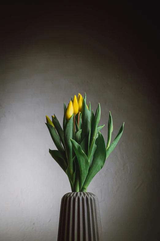 a bouquet of flowers with green leaves in a vase