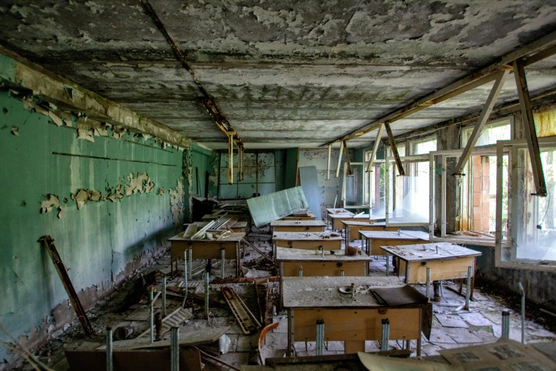 an abandoned classroom with many desks and boards