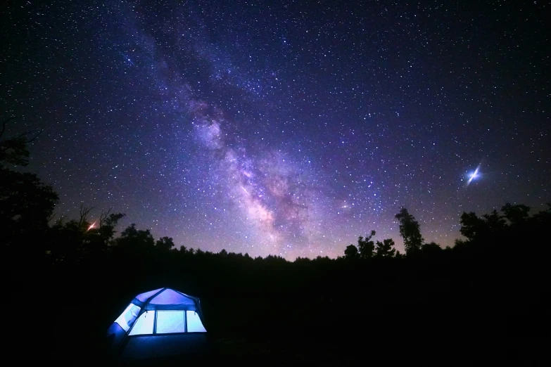 tents in the grass under a night sky