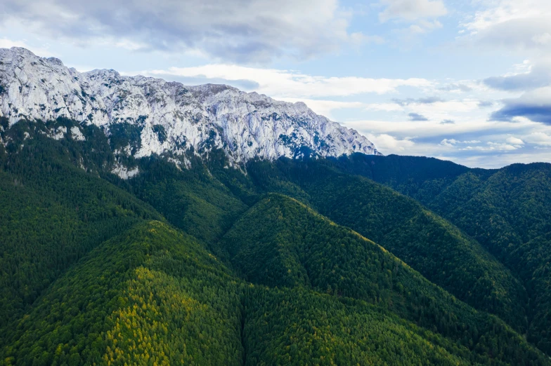 a mountain with mountains covered in snow