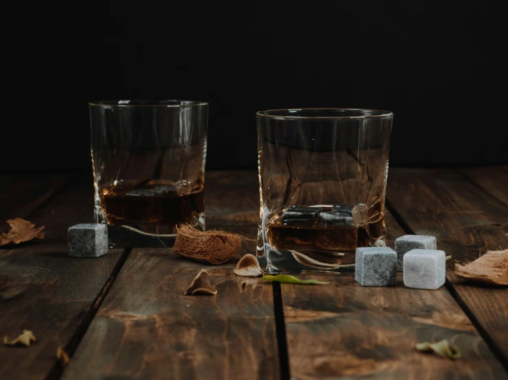 three glasses on a table full of alcohol