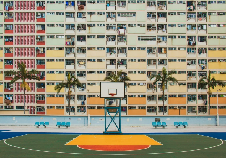 this is a view of an apartment building from the basketball court
