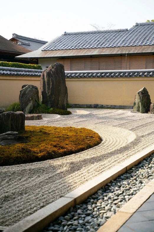 a courtyard in a house has rocks and grass