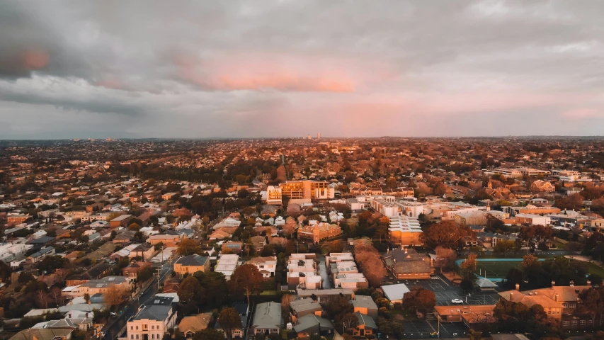 an aerial view of a city under a dark cloudy sky