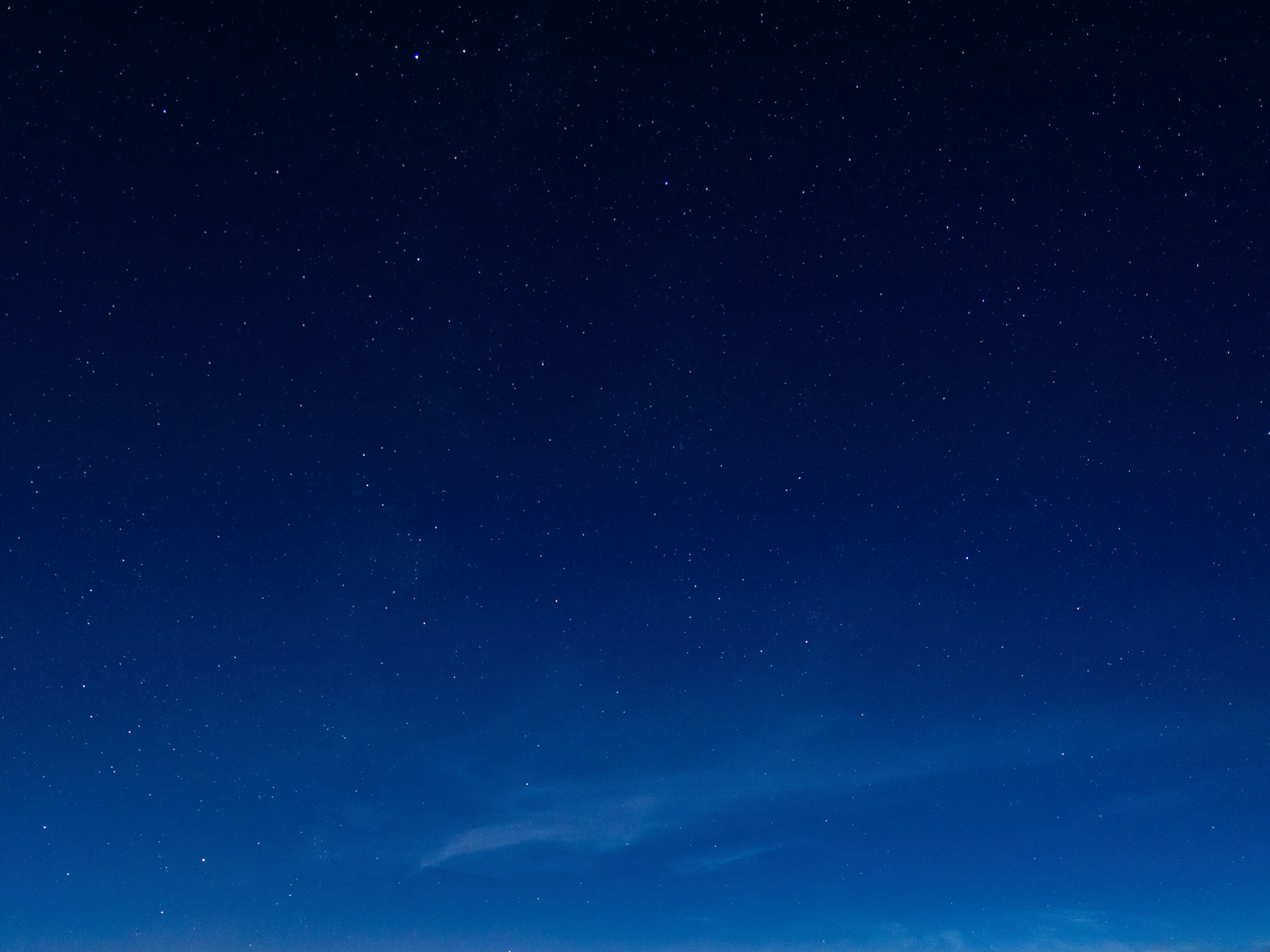 a person is holding their surfboard on a beach under some stars