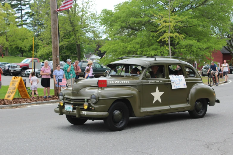 a military green truck that is parked in the street