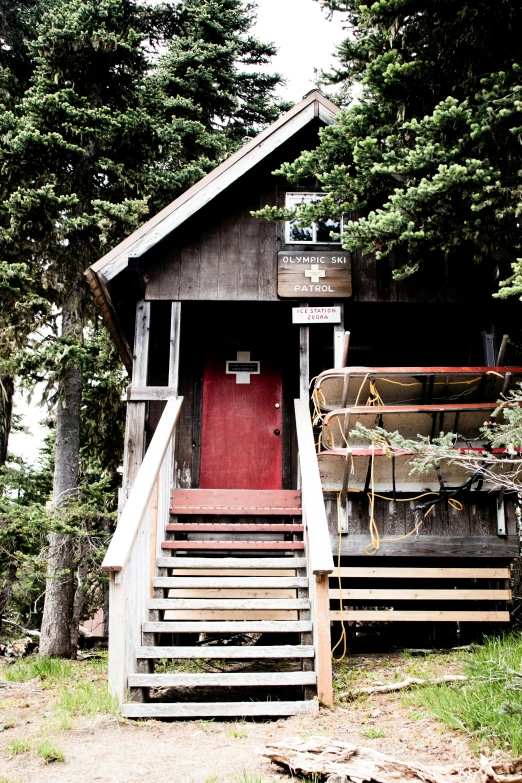 a house with stairs going down to a red door