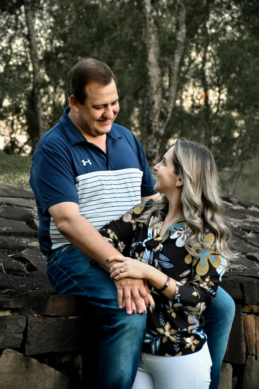 a man and woman hugging with their arms around each other