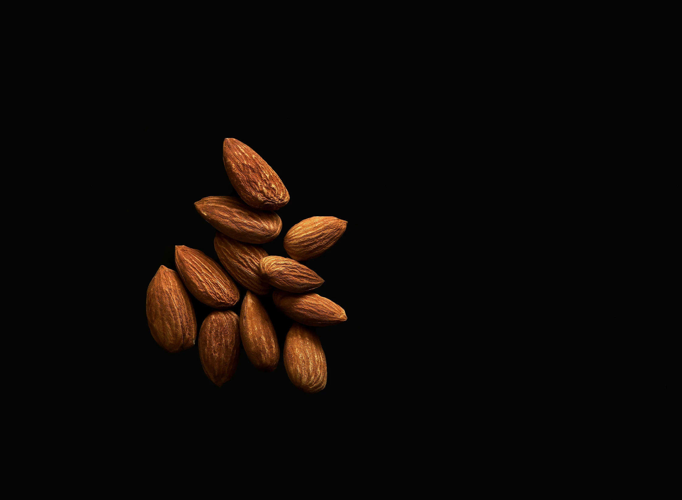 a cluster of nuts on a black background