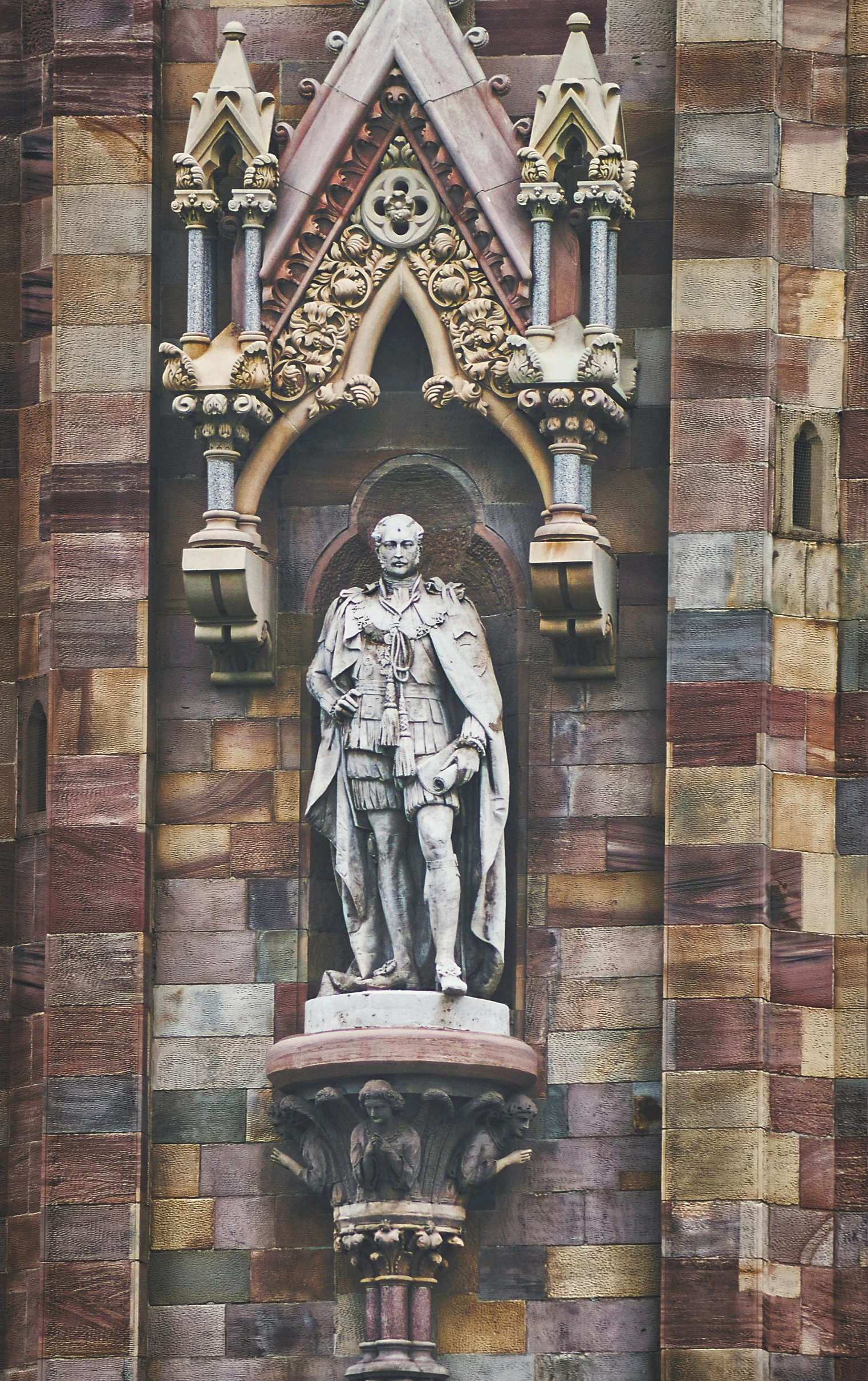 a statue on the wall of an old building