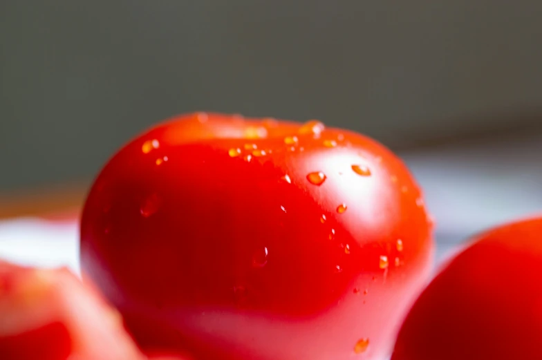 a bunch of red tomatoes on the counter top