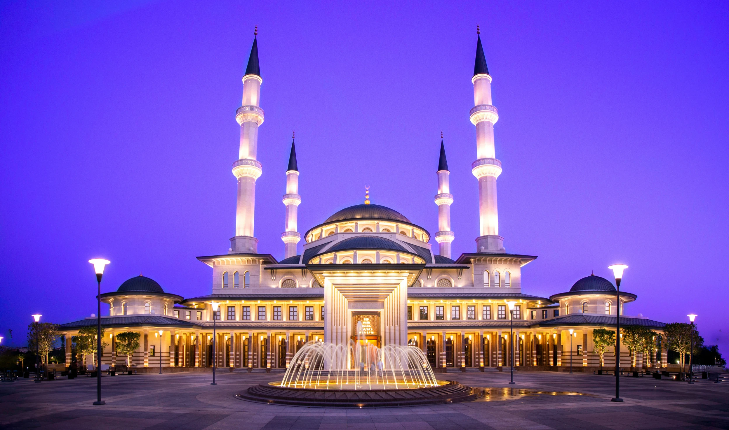 a large white building with some pillars lit up