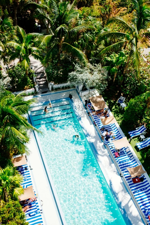 a very long swimming pool with blue chairs