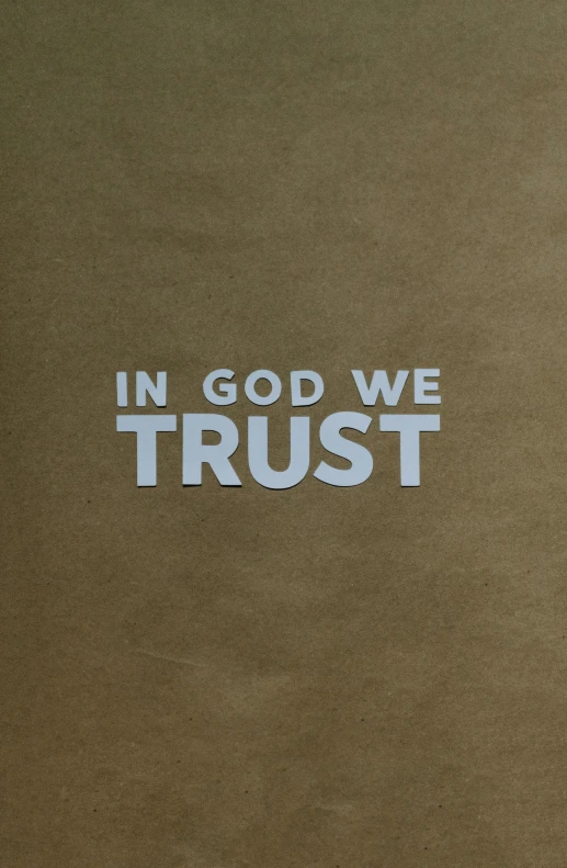 the words in god we trust are printed on the surface of a sheet of paper