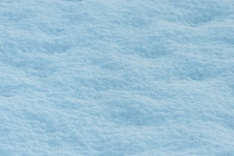 closeup of a snowy surface with a blue coating