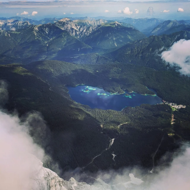 clouds and blue skies over the mountains and lake